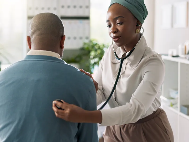 The image depicts a healthcare provider conducting examination of   a patient.